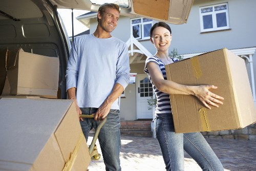Professional small removals team transporting office equipment